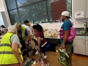 people in a line shopping at the pantry