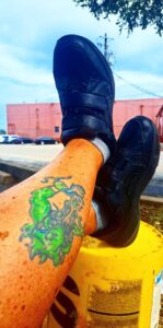 525967286_10231268976447869_5034900448870098041_n Tommy's tattooed legs with bright green design