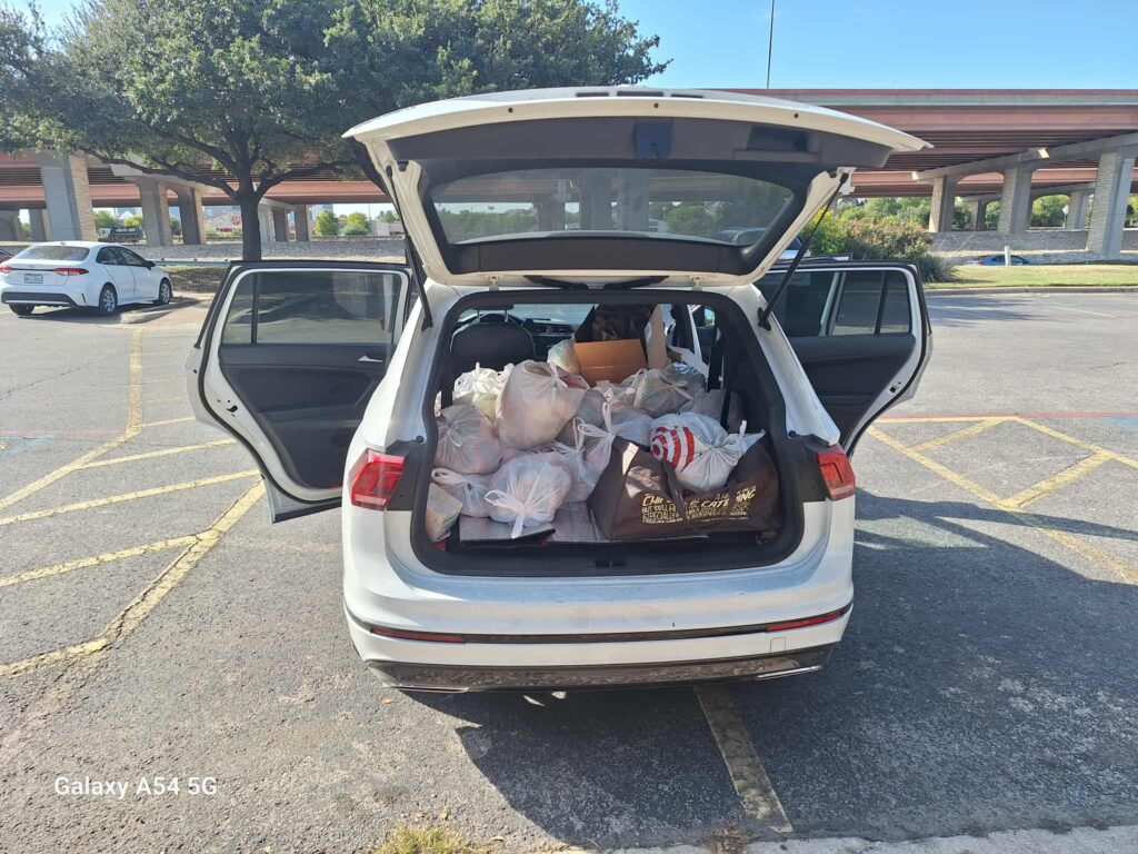 Unknown-29 white car full of bags of sandwiches