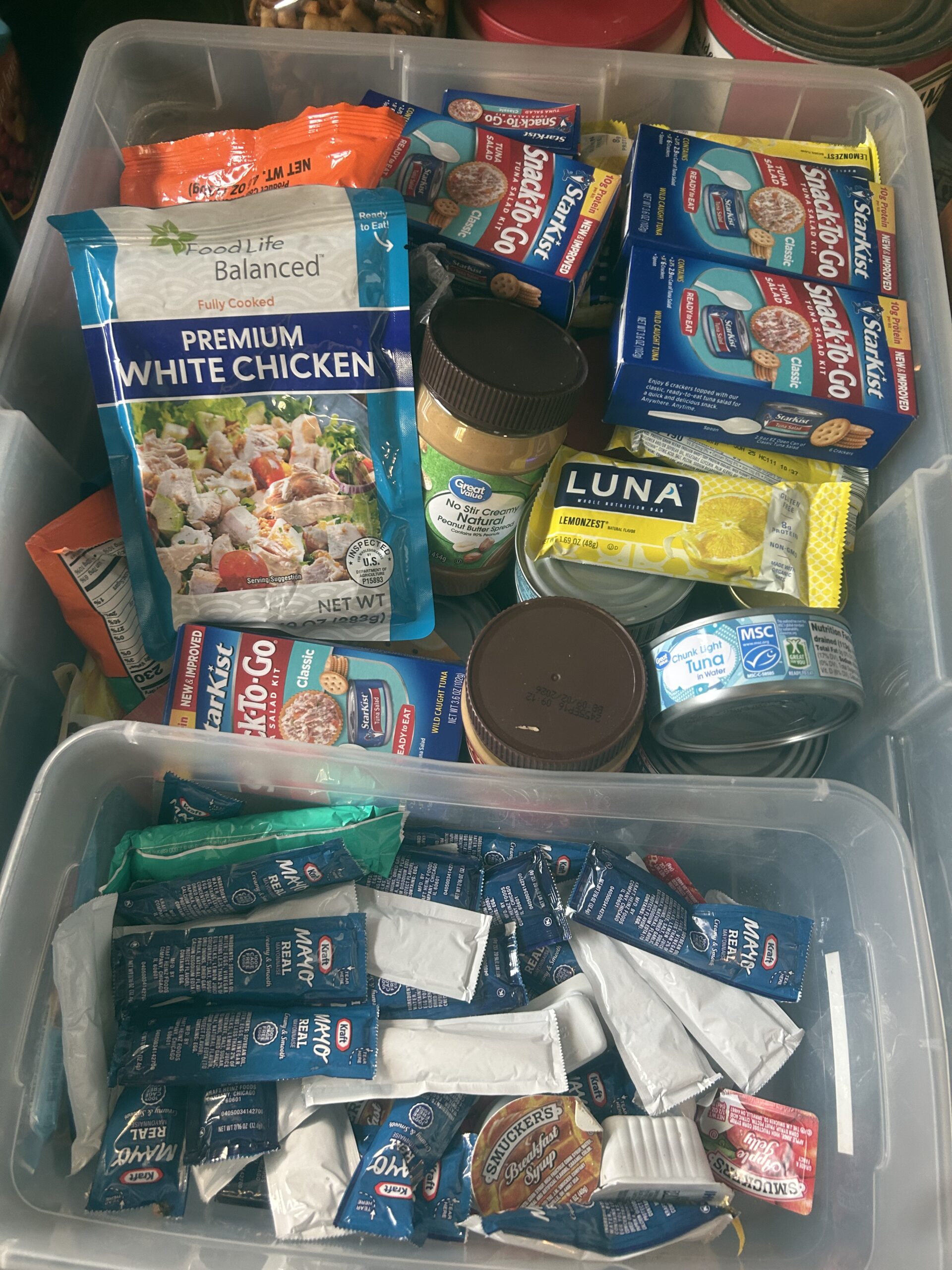 packages of brightly colored food, packages of may, chicken, peanut butter