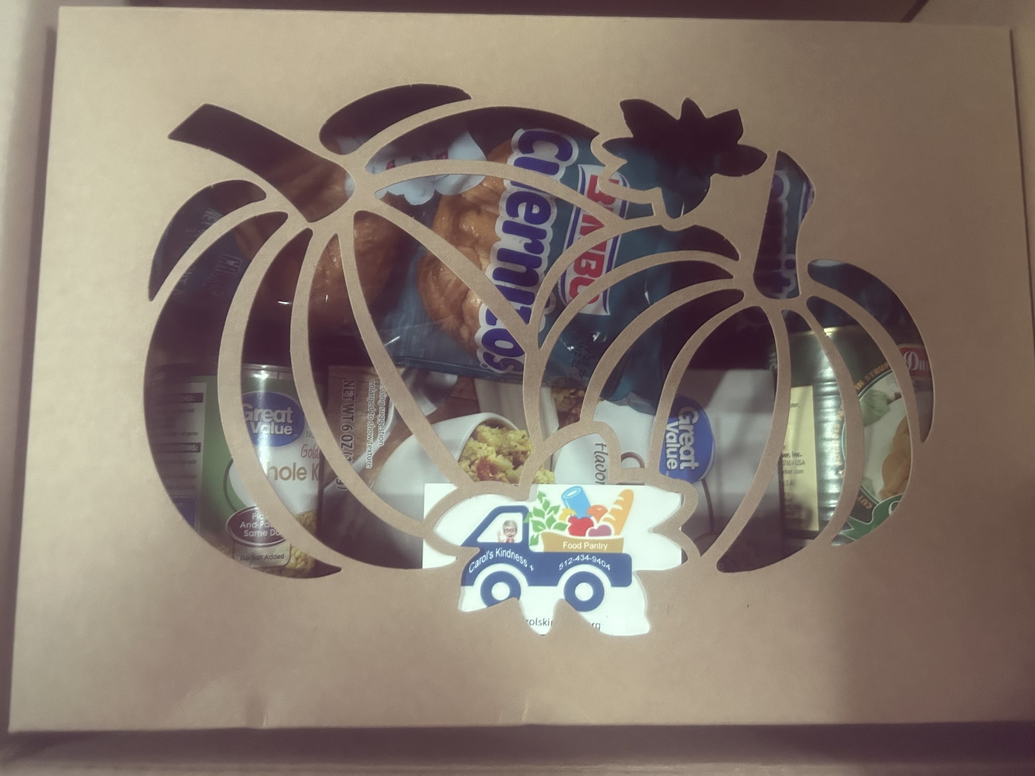decorated box with cutout pumpkin and colorful logo of car and food