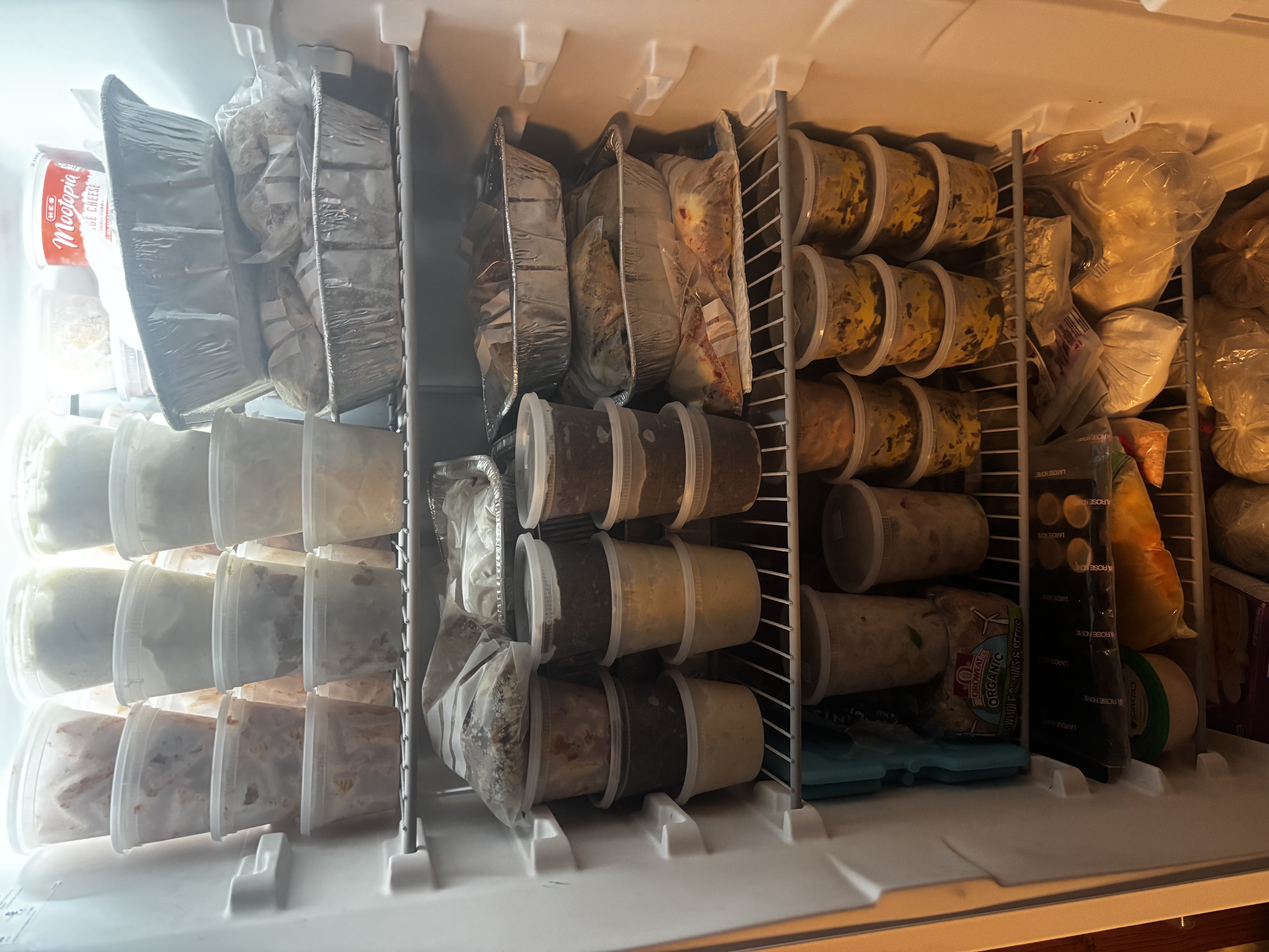 variety of containers of food in freezer